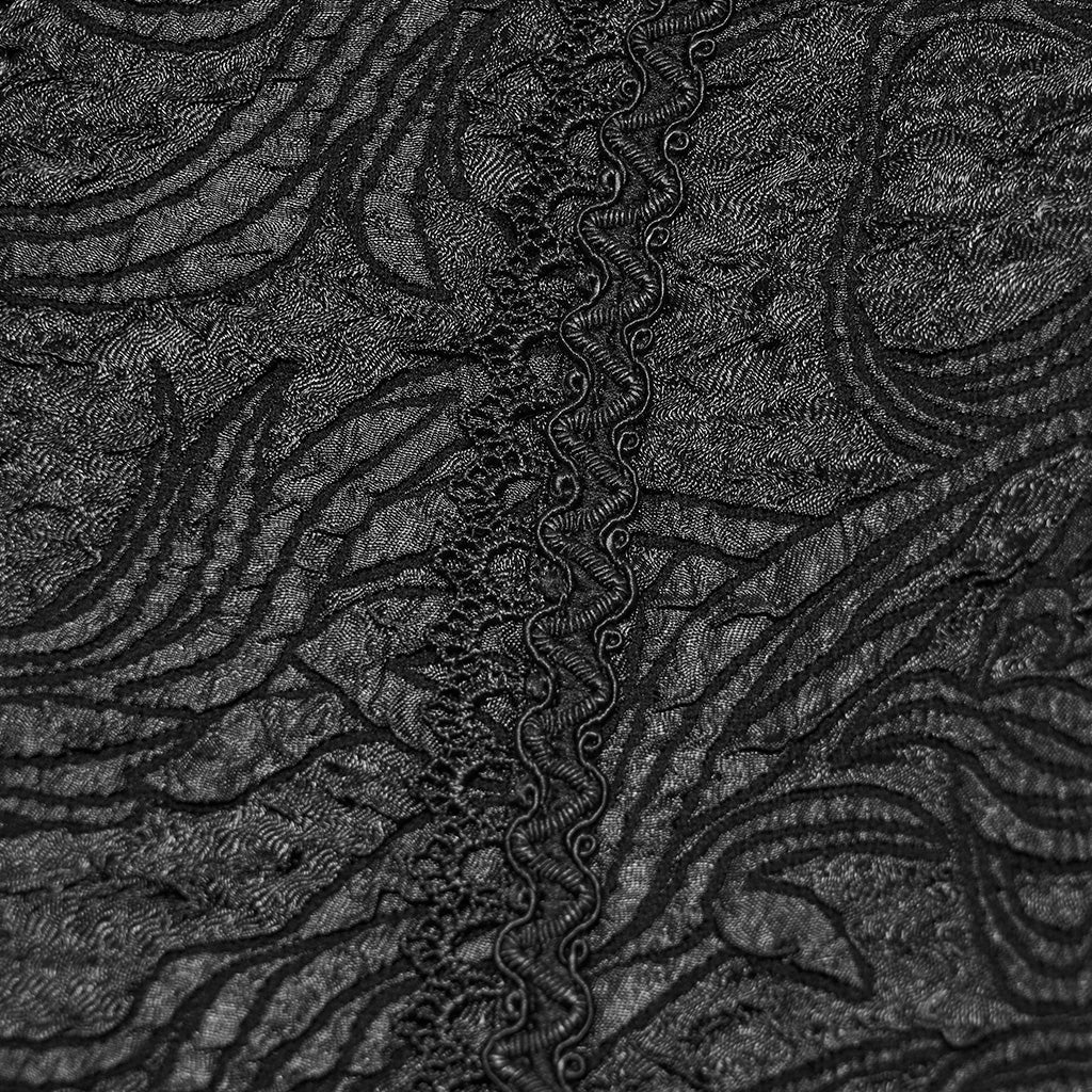 Detalle del cordón trenzado en zigzag sobre el jacquard negro